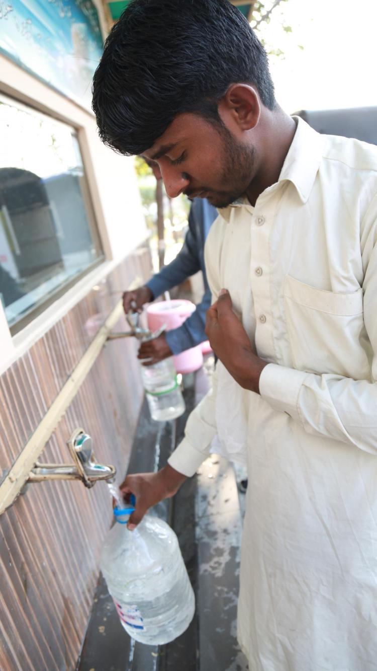 Man getting water from Water ATM