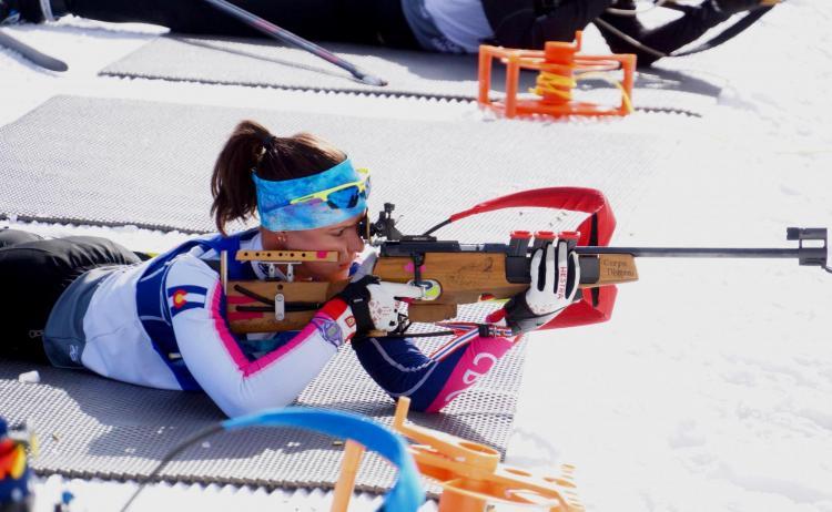 Joanne Reid pointing a rifle at her Biathlon target.