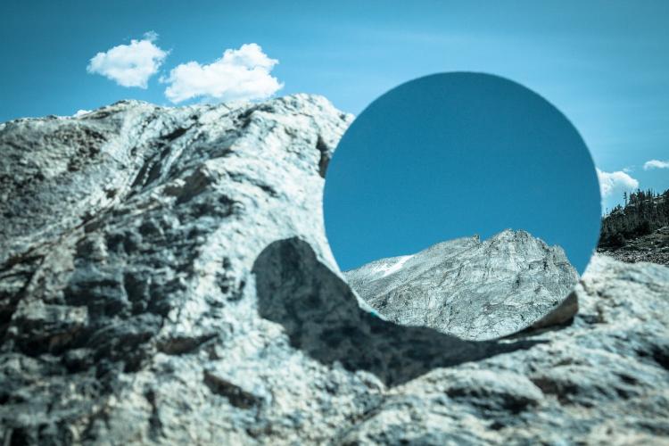 Kevin Hoth's photo of a mountain peak that also contains a circle with a closeup of the peak.