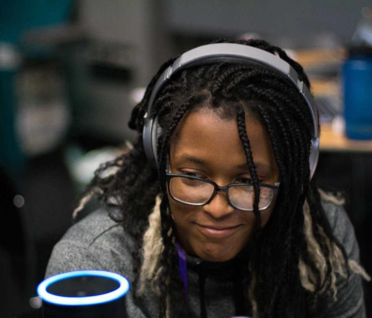 Woman engaging with technology at T9Hacks