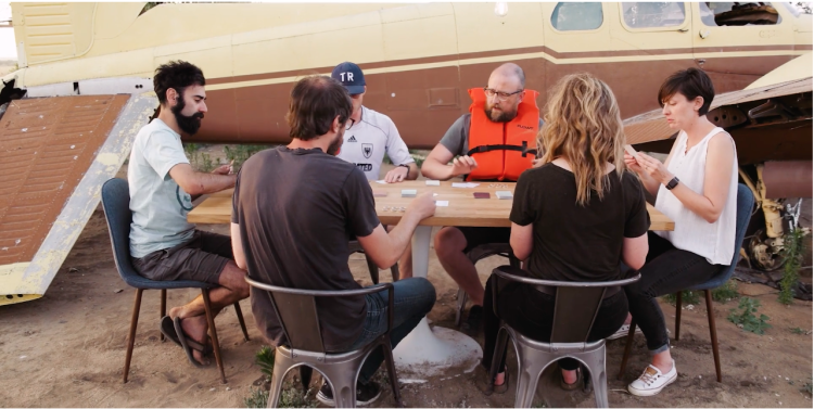 Scene from the Ravine promo video with six players playing ravine next to an old plane.