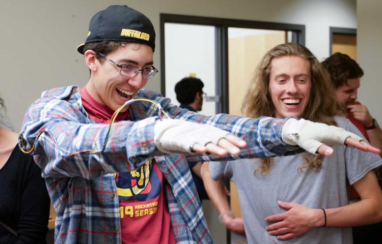 student using wearable technology laughing