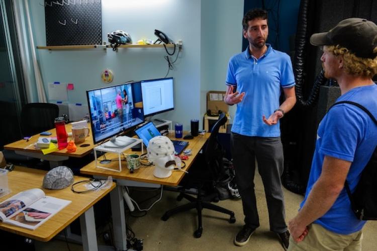 A PhD student demonstrates a neuroscience-based project to a guest