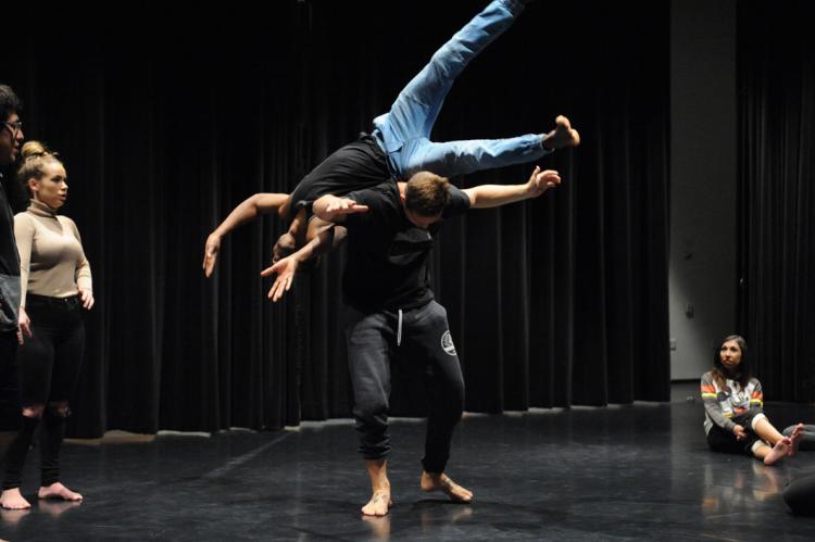 one dancer lifted on the back of another dancer