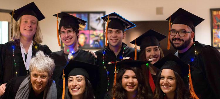 Students in regalia pose as a group.