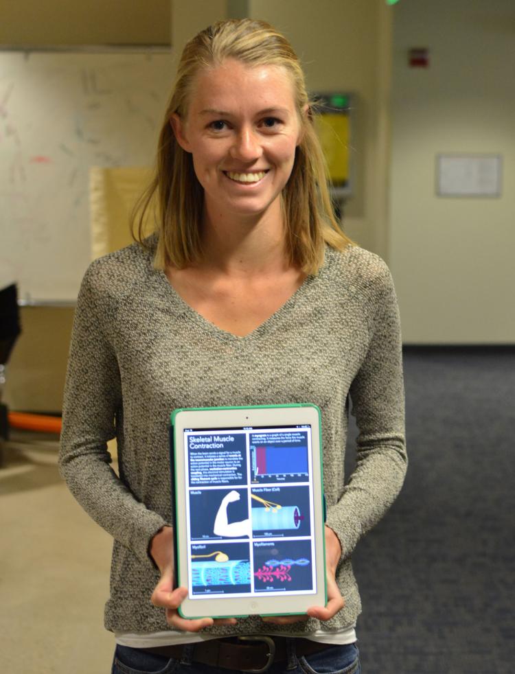 Megan Leahy holds The Explanimated Textbook - An animated and interactive iBook.