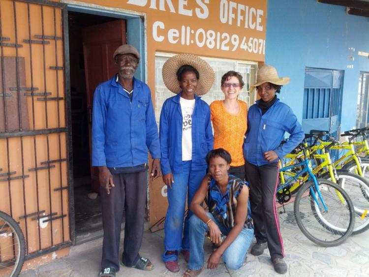 Social Impact student is photographed with smiling locals
