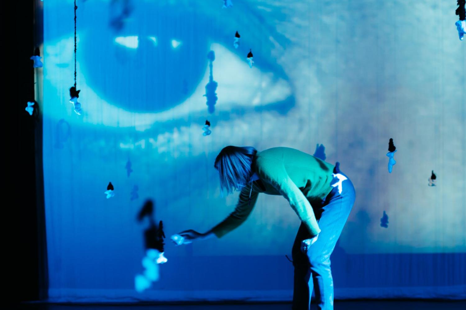 person playing with suspended sculpture