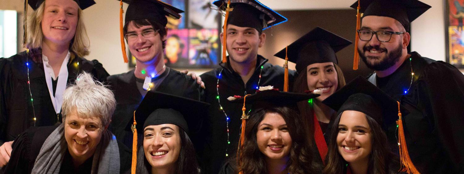 Students in regalia pose as a group.