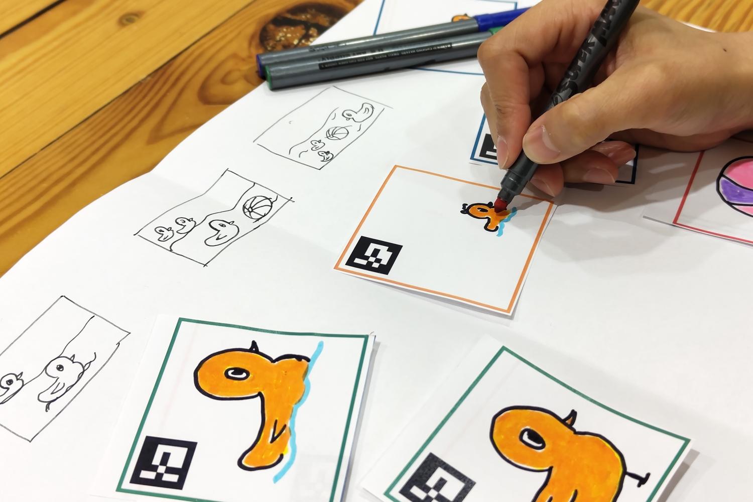 Person coloring cartoon drawings of ducks