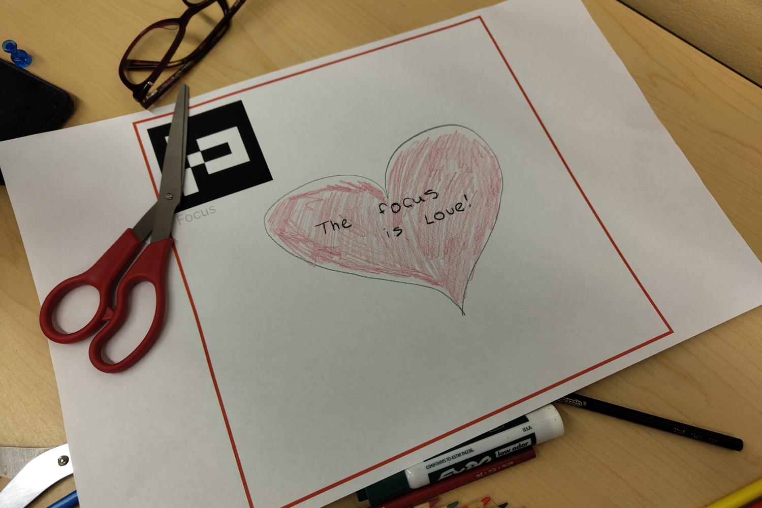Colored pencil heart drawn on paper
