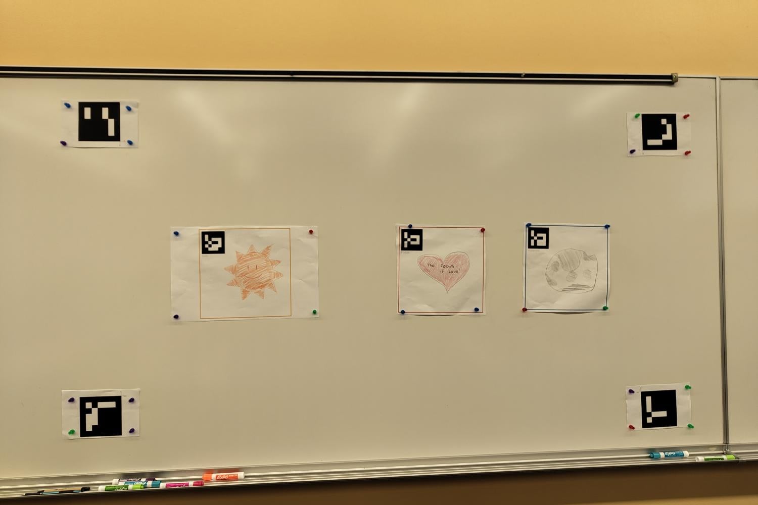 Cartoon images drawn on paper, pasted on a whiteboard