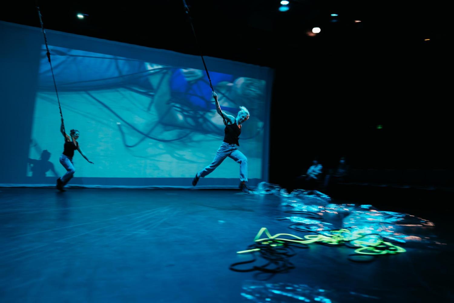 two dancers in mid air