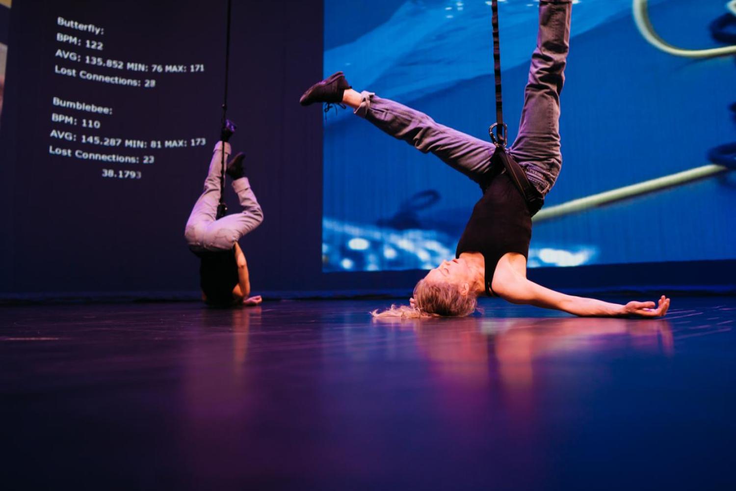 two dancers relaxing while performing