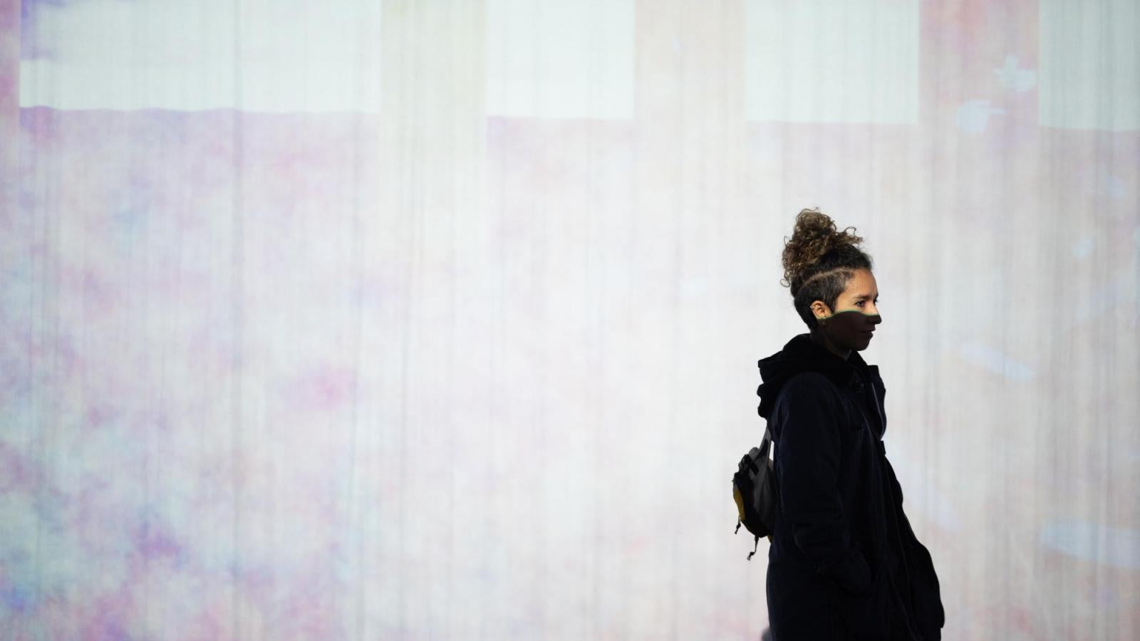 someone walking in front of a projection