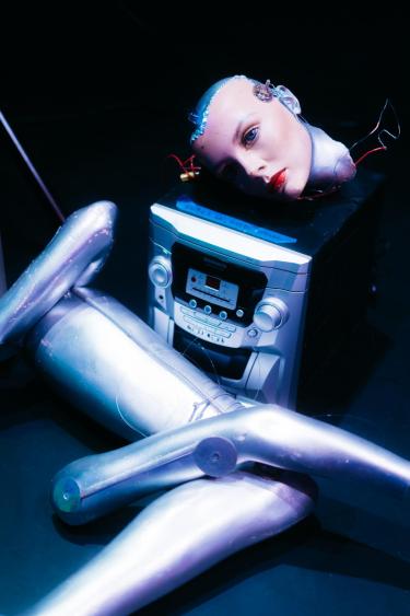  mannequin head lying on CD player