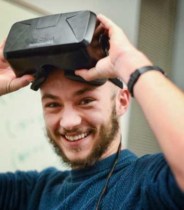 Male student enjoying a Virtual Reality headset