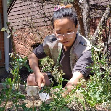 Shanel Wu working in a garden