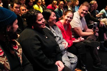 First Lady Johnston and her team sit in the audience in the Black Box