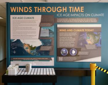 The exhibit includes a wall with the heading Winds Through Time: Ice Age Impacts on Climate Change with diagrams of the details