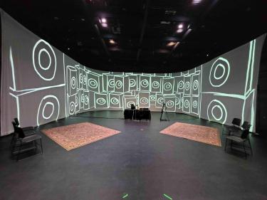 Sonic Summit stage setup with illustration of speaker around in 270-degree surround theater