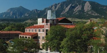 ATLAS Institute building in spring with the Flatirons in the background