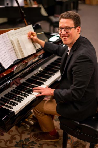 ben sitting at a piano