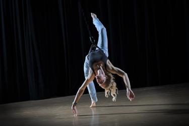 anna dancing in a harness lightly connecting to the ground