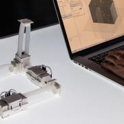 Photo of ShapeBots next to laptop