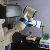 Robochemistry robotic arm pouring liquid from one beaker into another