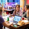 A T9 Hacks team of 3 students sit at a table in the BTU Lab