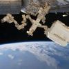 Robot arm hovering above Earth.