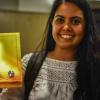 Woman holds up her project