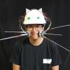Chris Hill wearing his  Whiskers project, including a hat that looks like a cat.