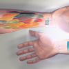 Two arms showing a CU tattoo on one arm and numbers on another, illuminated by UV light.