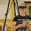 Research subject wearing augmented reality headset working with drone.
