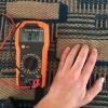 textile and a hand with muiltimeter on top