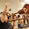 During the Moog Hackathon, Ruhan Wang demonstrates the e-trombone to the delight of other hackathon participants.
