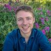Sam Stevens with wildflowers behind him.