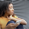 Teenage woman holding her cell phone