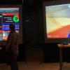 Participants at the Whaaat!?Festival playing videogames on large screens.