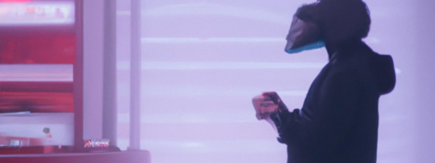 AI generated image of a person wearing a VR headset standing in front of futurist red structures.
