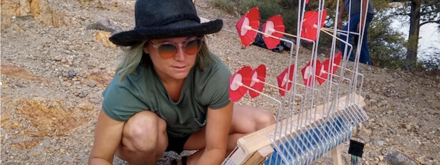 Person using wind loom outside
