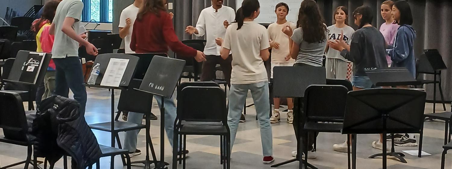 Group of people singing in a circle