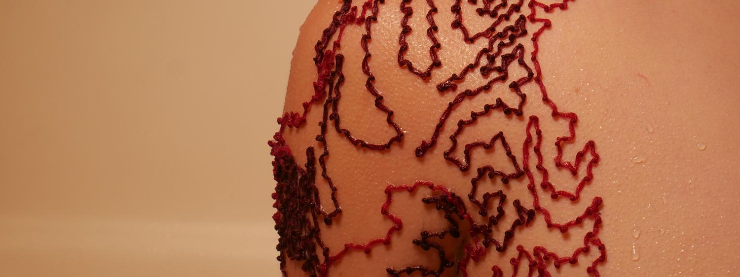 a close up of a shoulder ensnared by a jagged linear red contour