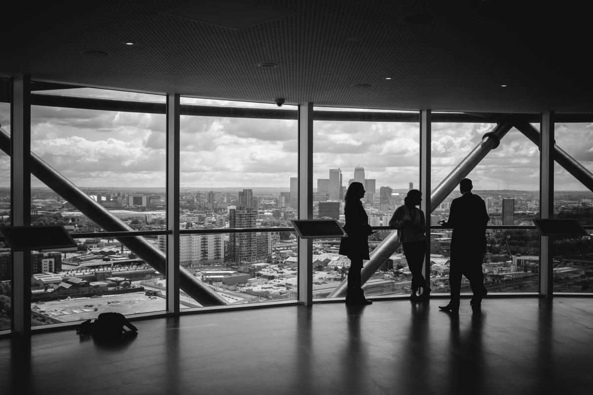 Building with silhouettes of people in suits