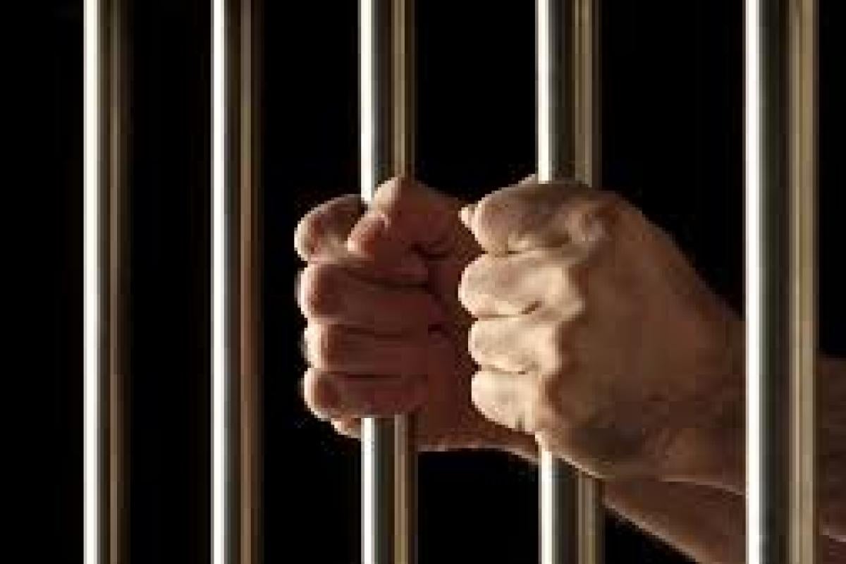 Hands behind bars
