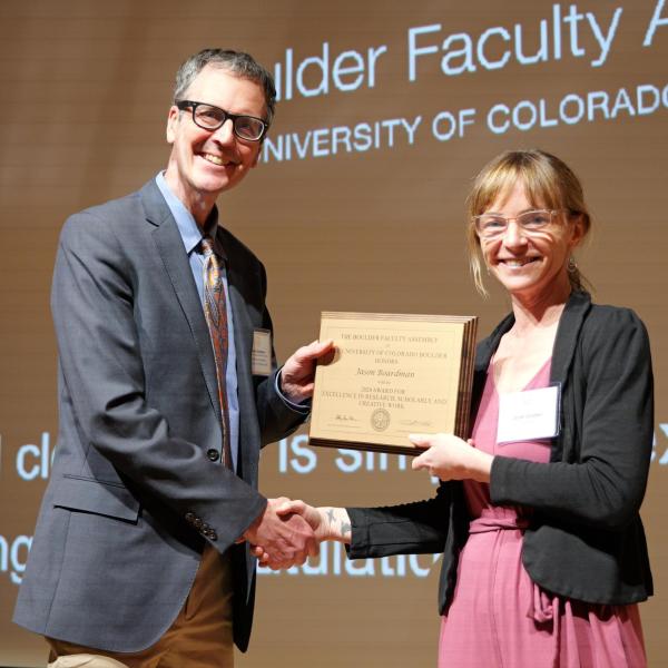 June Gruber presents Excellence in Research award to Jason Boardman