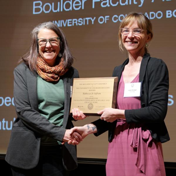 Research awardee Safran receives plaque from selection committee chair June Gruber