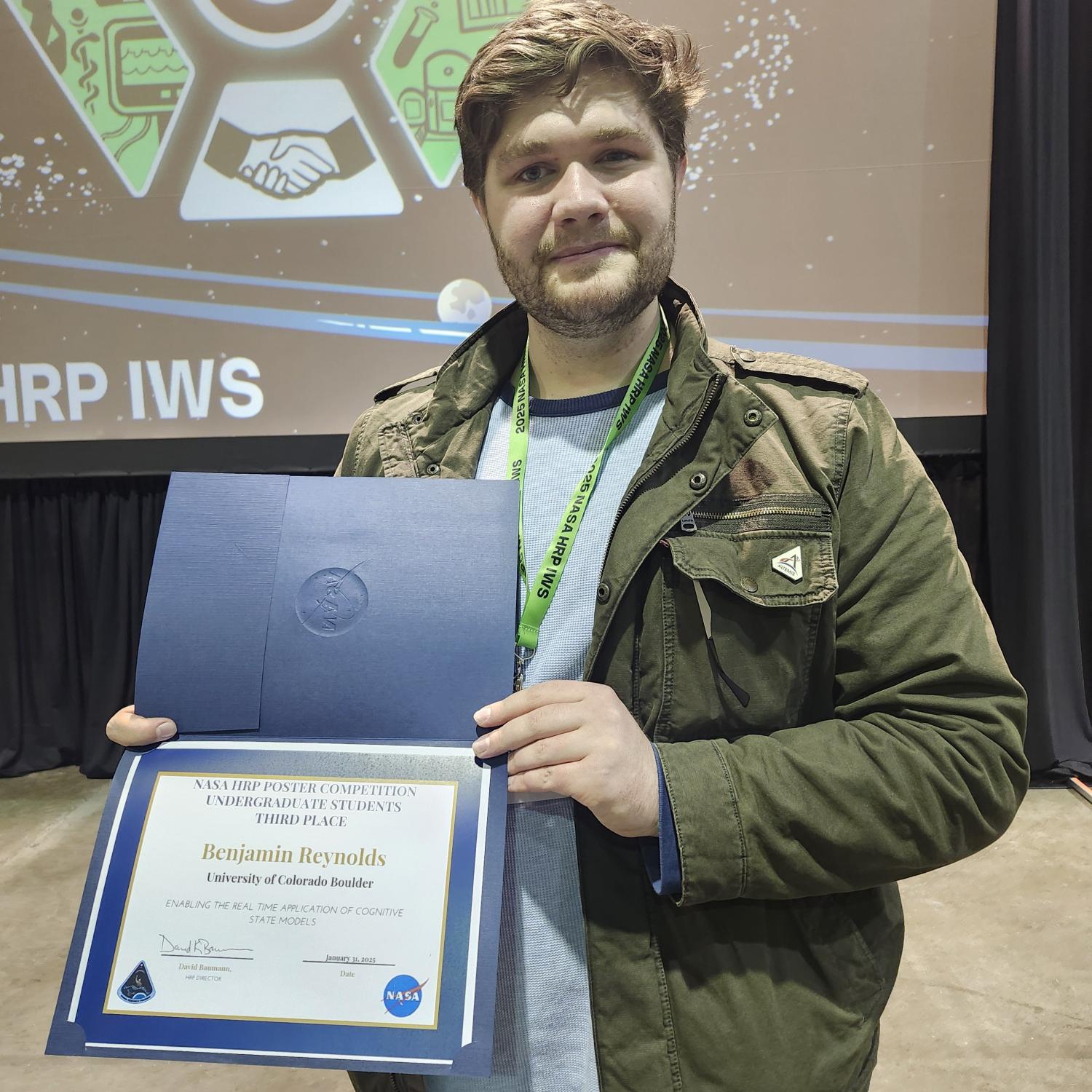 Picture of Benjamin Reynolds with his 3rd Place Undergraduate Poster Award.